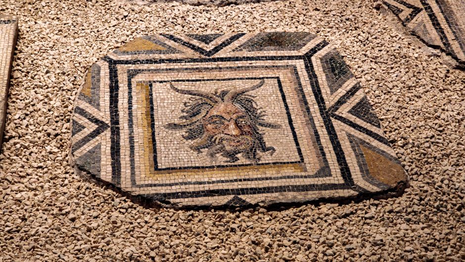 Close-up of the preserved 4th-century Roman mosaic floor in Constanța under protective glass