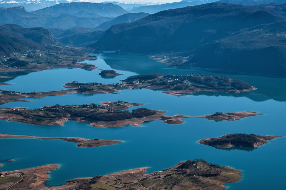 The Una River rushing past small islands in the center of Bihać