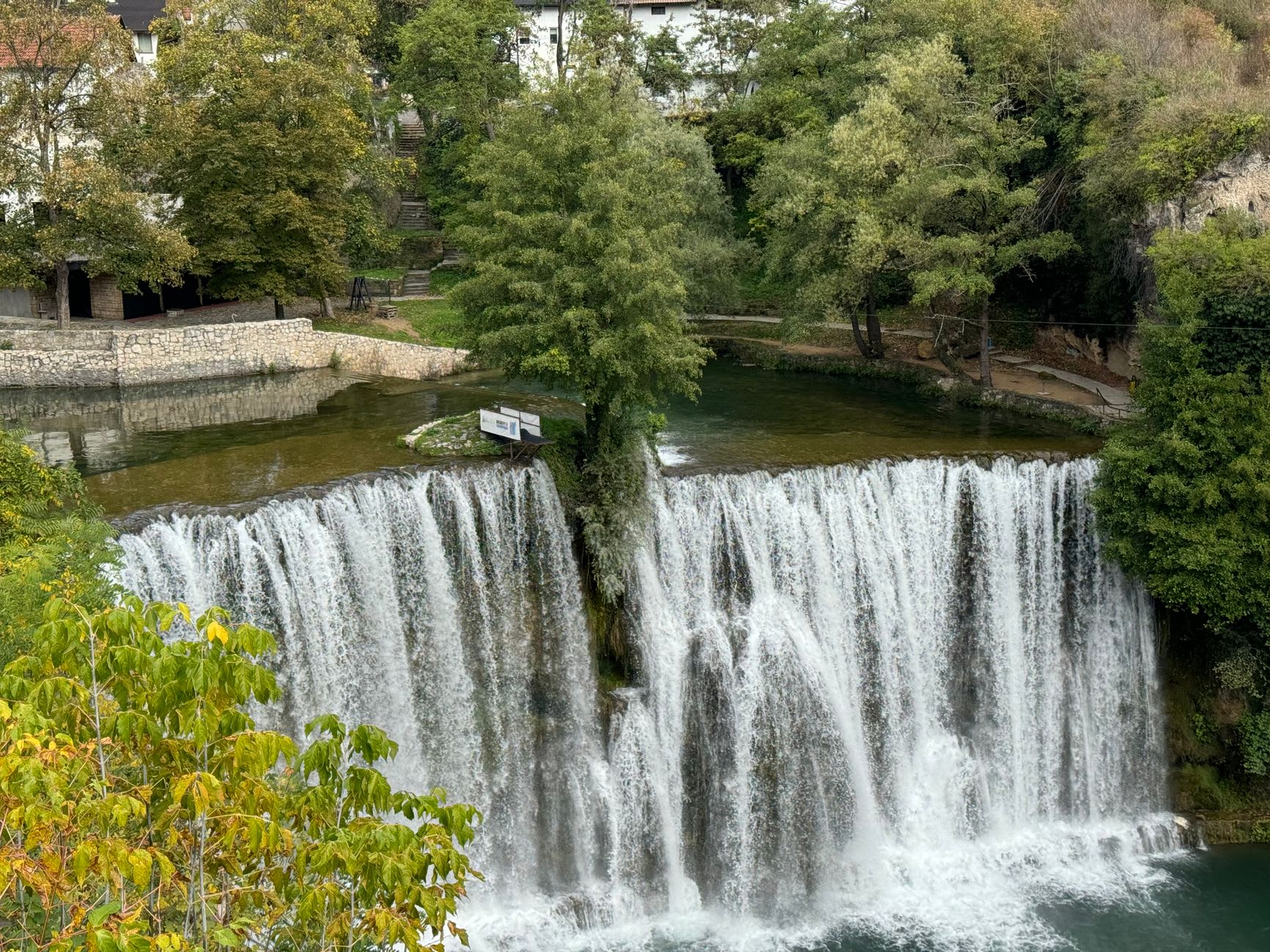 The Trebižat river downstream from Kravice, its jade water running between banks of wild cane and fig trees in the Herzegovina summer