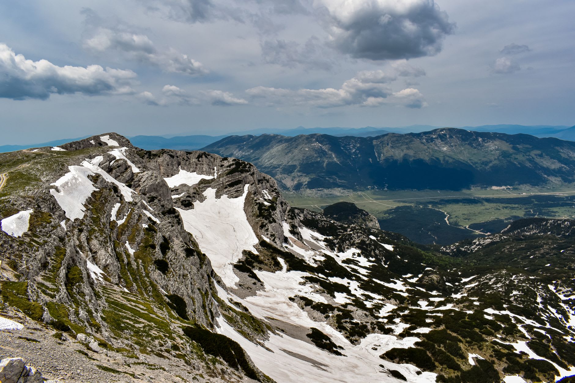 Trnovačko lake high in the Maglić massif, its glacial water reflecting the surrounding limestone peaks on a still morning
