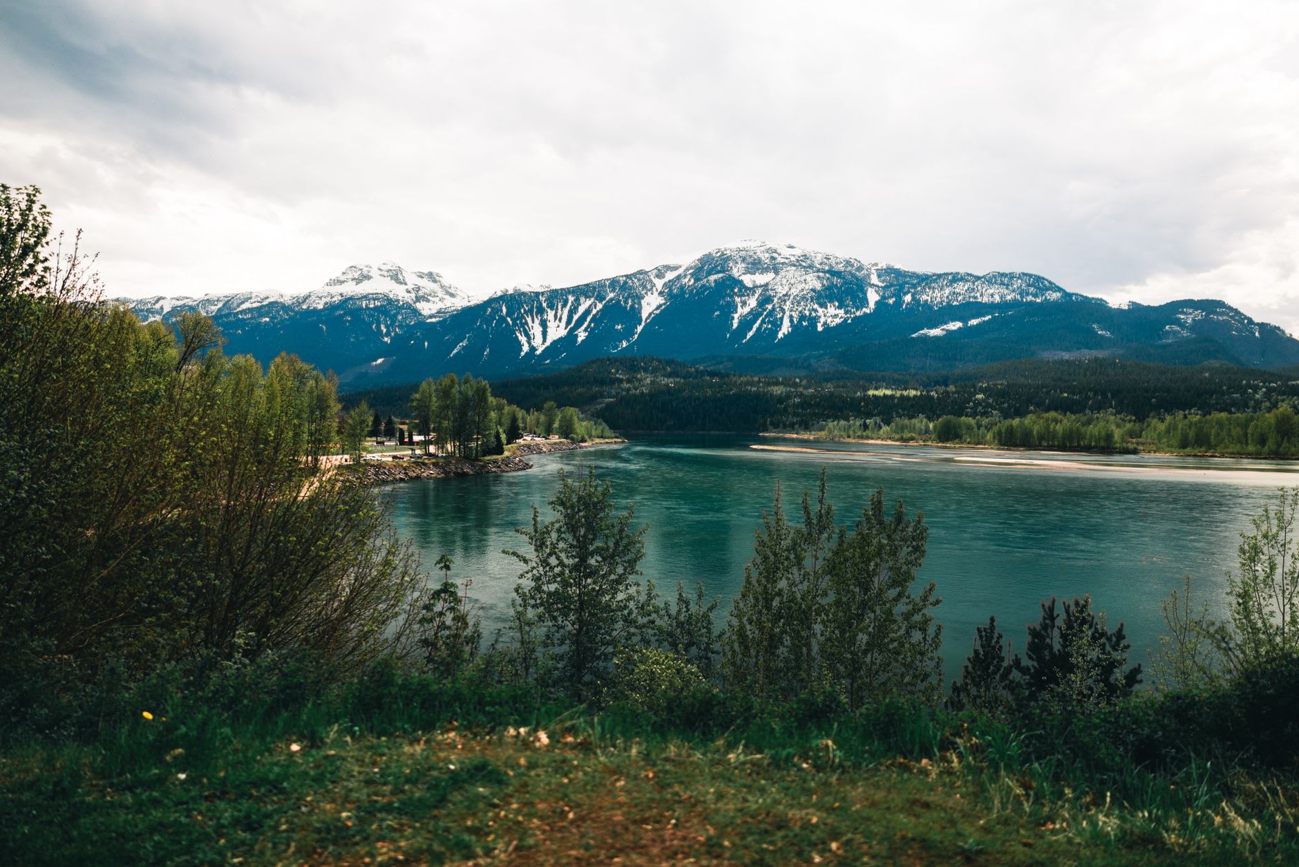 The Meadows in the Sky Parkway switchbacking above Revelstoke with the Columbia River valley visible thousands of metres below and the Interior ranges extending to the horizon