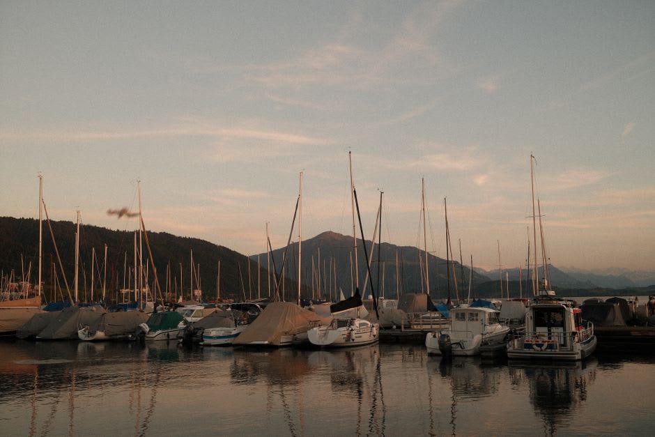 Sunset over the anchorage at Soper's Hole with sailboats moored in the calm harbor and the last light on the water