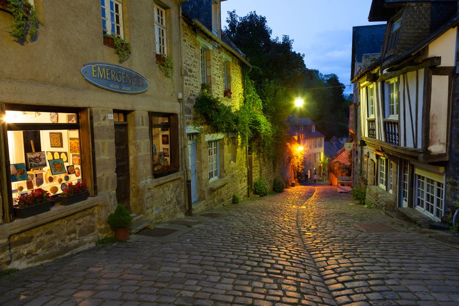 Cobblestone lane between granite merchant houses on a misty morning in Locronan