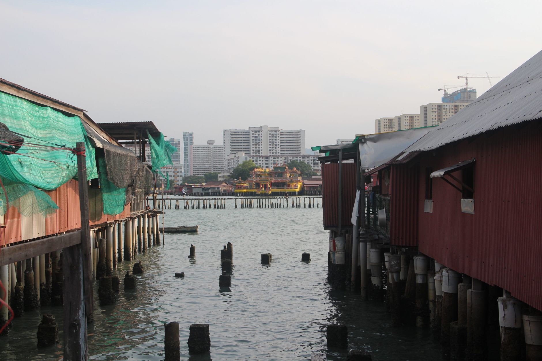 Wooden boardwalks connecting the stilt houses of Kampong Ayer with laundry strung between the homes