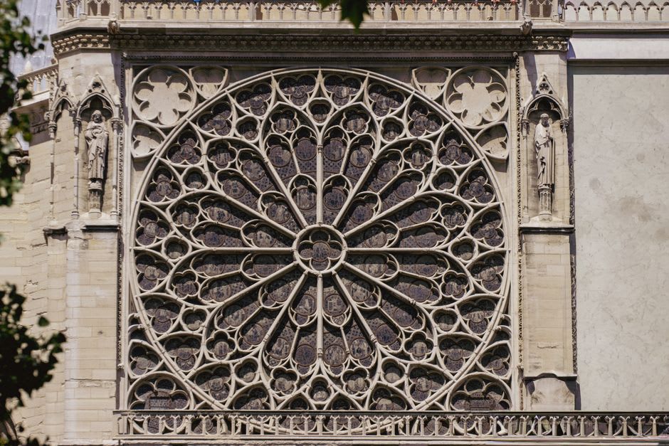 Carved Gothic portal and rose window of the Collégiale Notre-Dame in Semur-en-Auxois