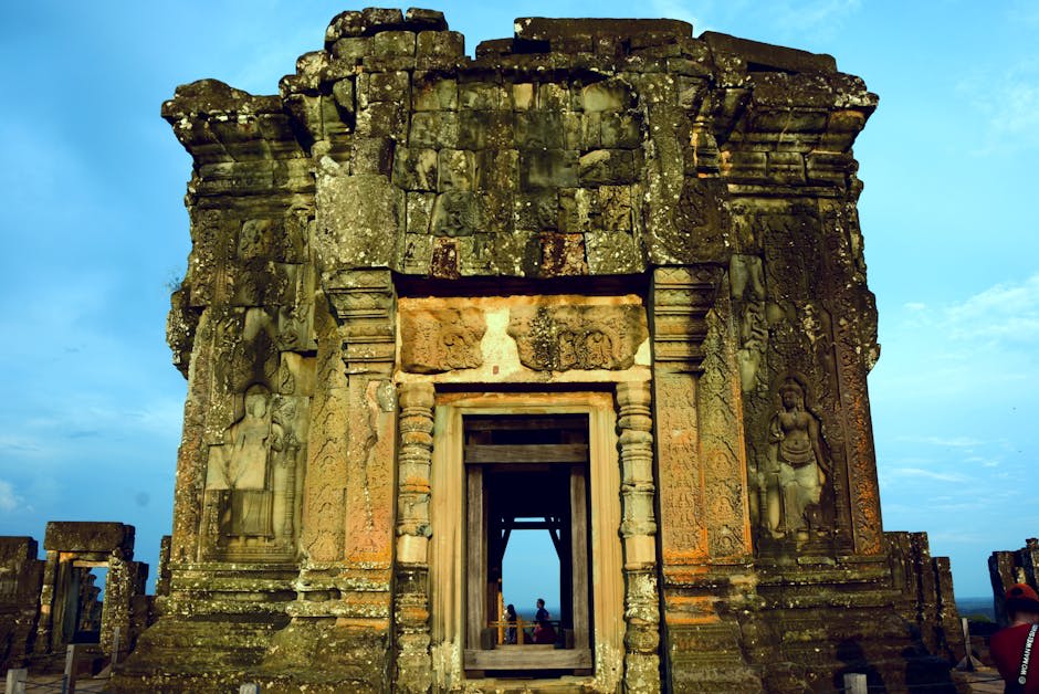 Serene temple pathway framed by ancient trees in Angkor complex