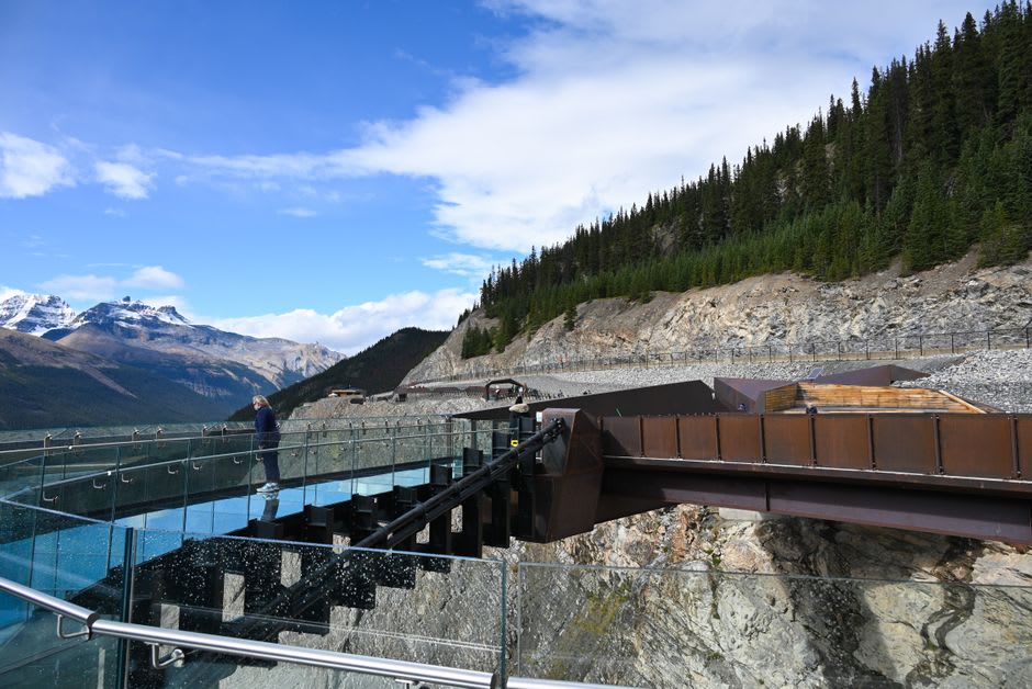 Glass-floored Skywalk platform extending over the deep valley below the Columbia Icefield