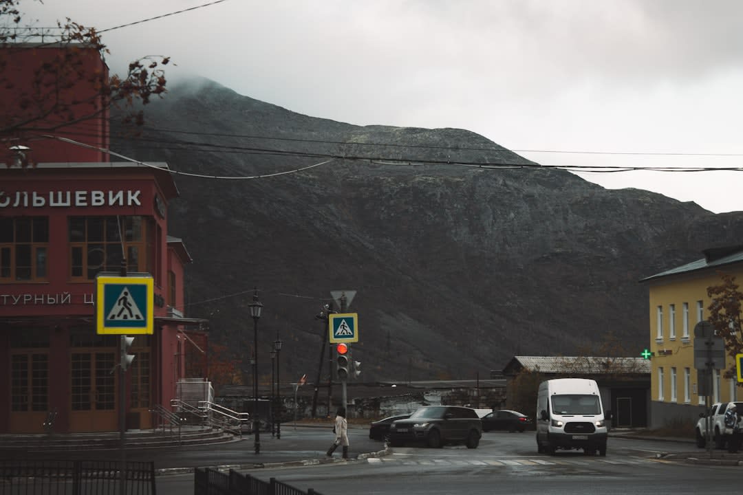 Historic brick main street with mountain peaks visible at the end of the road