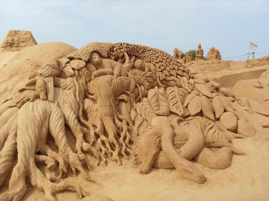 Elaborate sand sculpture on the public beach at Harrison Hot Springs with the lake behind
