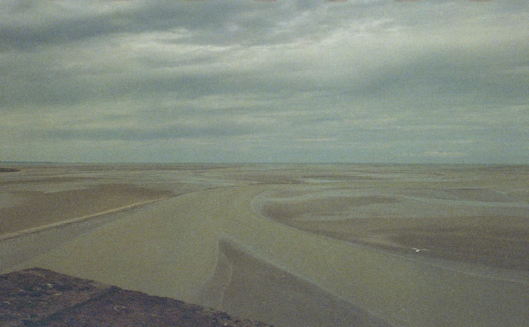 Exposed mudflats at extreme low tide in Frobisher Bay near Iqaluit with a small boat resting on the mud