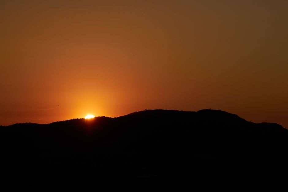 Sunset over La Cloche Mountain ridgeline from a granite campsite