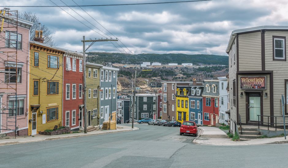 Colorful row houses along a steep hillside street in the historic old town of Lunenburg