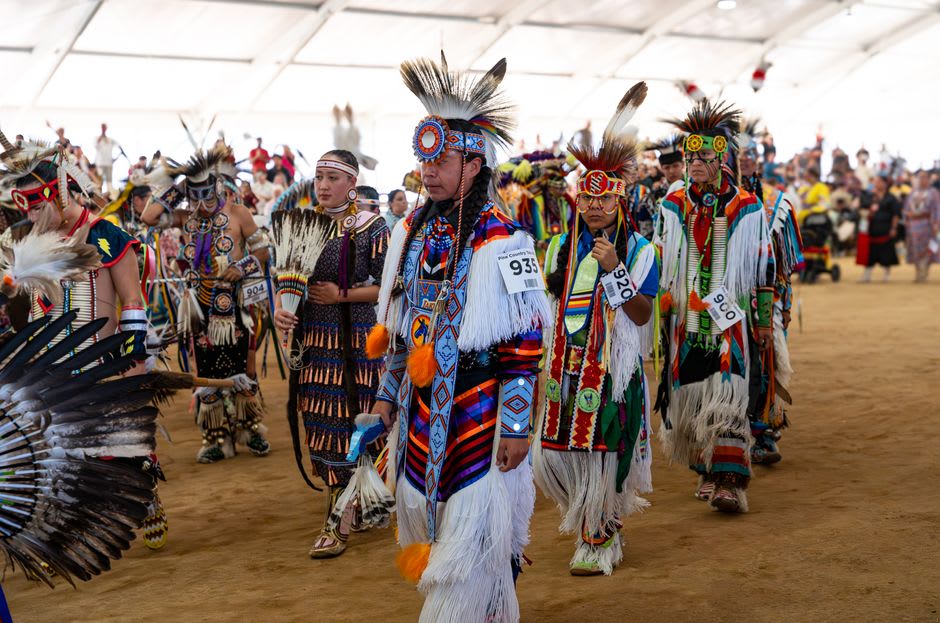 Dancers in regalia at the Wikwemikong Pow Wow gathering