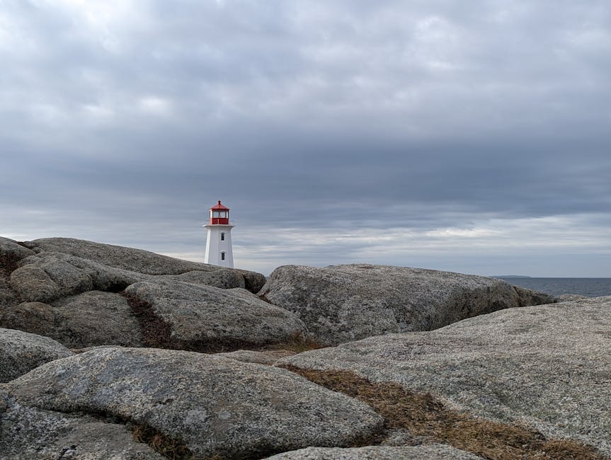 Lighthouse standing guard over a foggy Nova Scotia headland