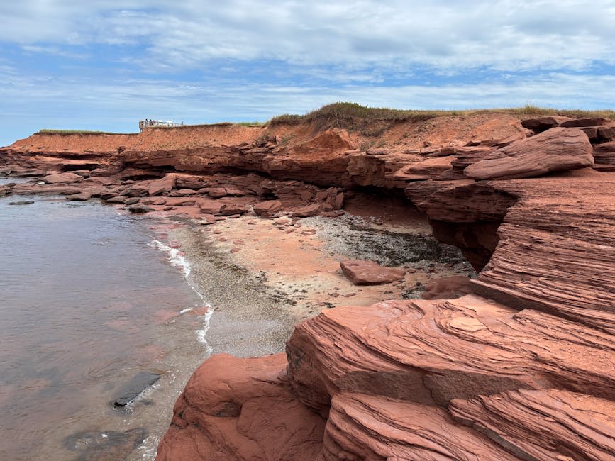 Red sandstone cliffs meeting the blue waters of the Gulf of St. Lawrence