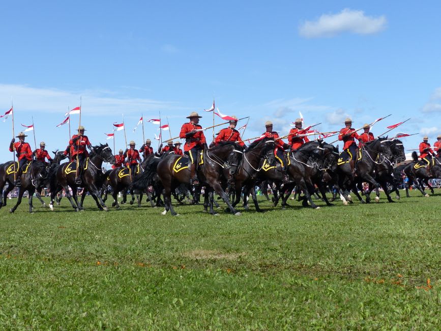 Row of RCMP cadets in red serge uniform marching during the Sergeant Major's Parade at Depot Division