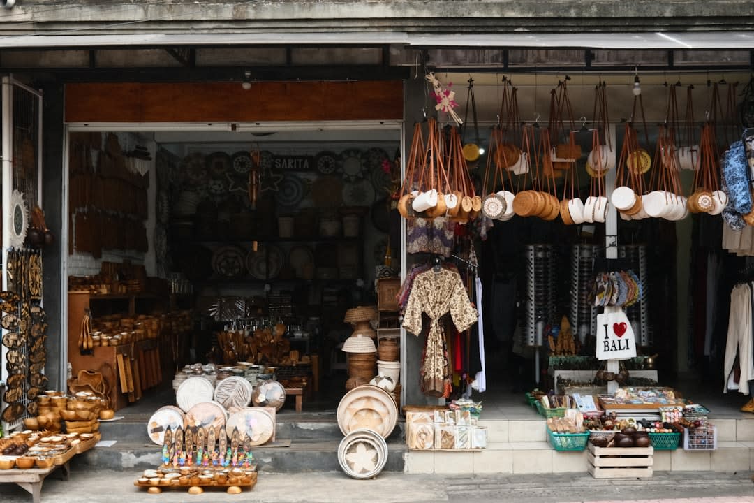 Bustling outdoor artisan market stalls with handmade pottery and fresh produce