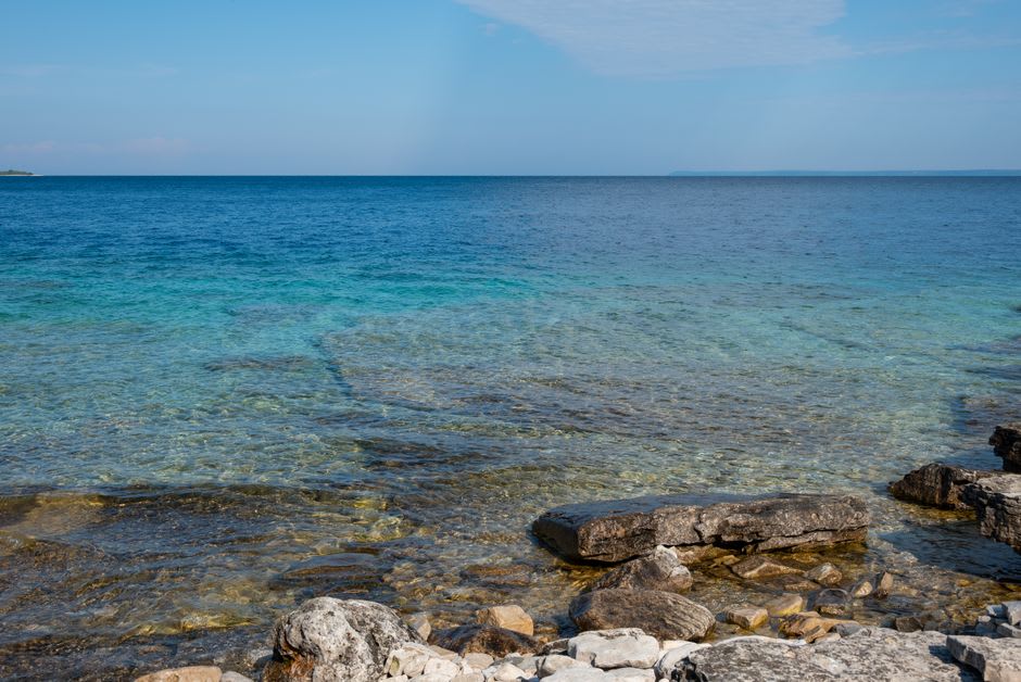 Shipwreck timbers visible through crystal-clear turquoise water near Tobermory