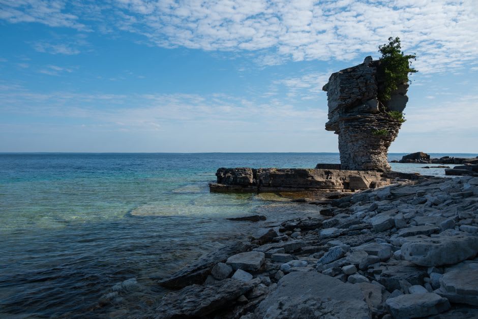 Flowerpot Island's distinctive sea-stack rock formation rising from turquoise Georgian Bay water