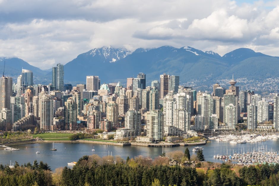 Vancouver harbour with mountains rising behind the glass skyline