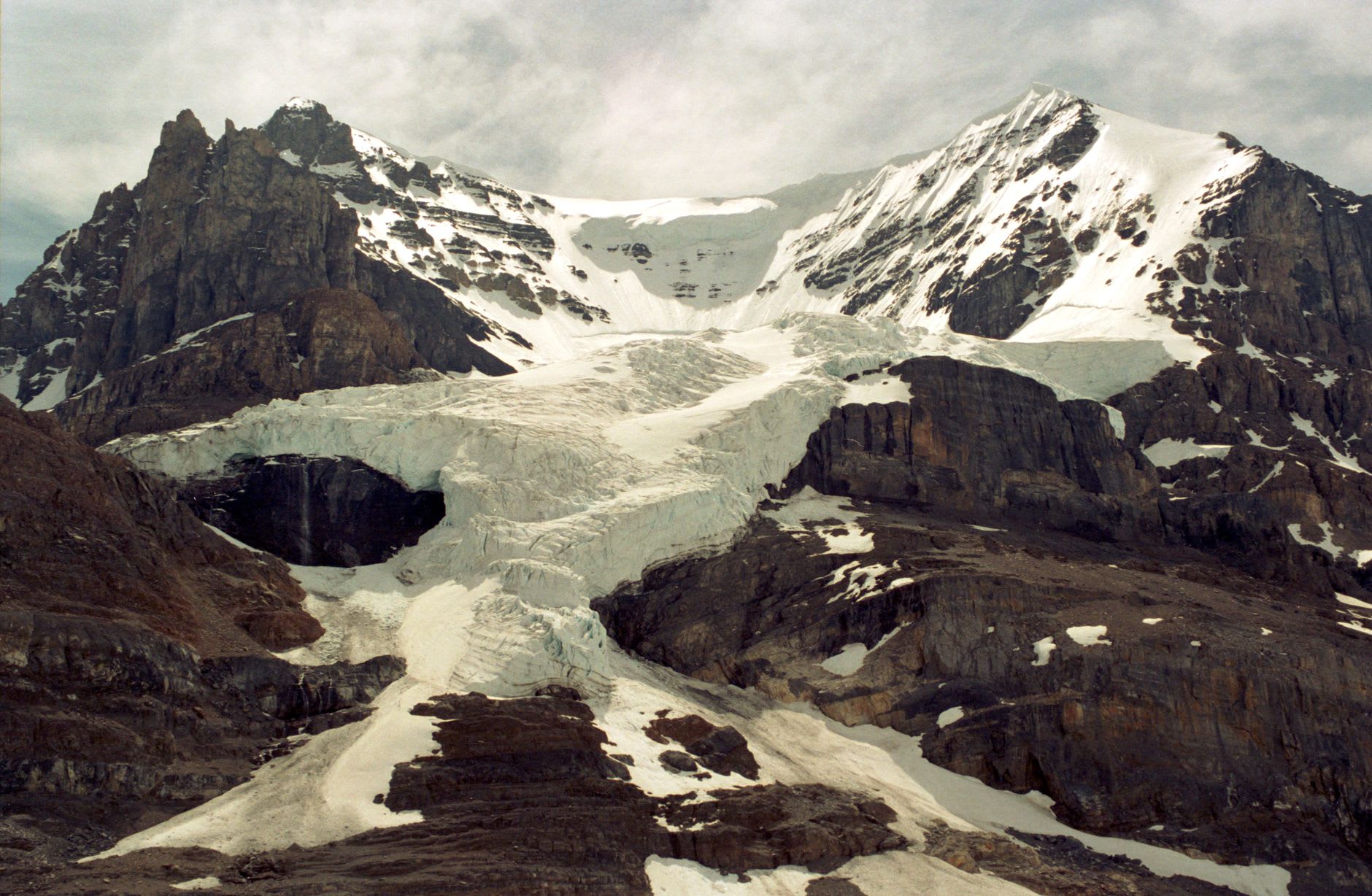 Retreat markers in the valley below the Athabasca Glacier showing decades of glacial recession stretching back toward the road