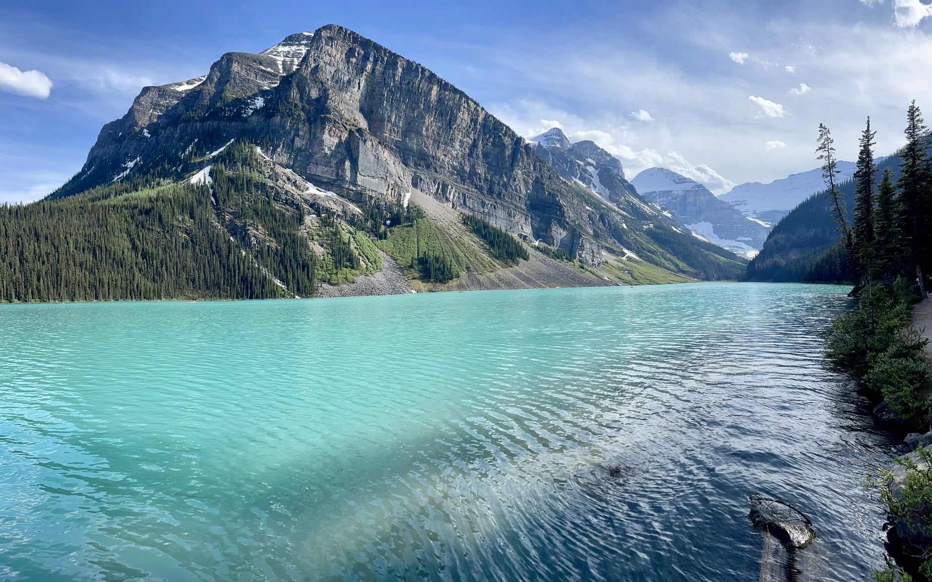 Dawn light turning Lake Louise from silver to turquoise with Victoria Glacier looming at the far end