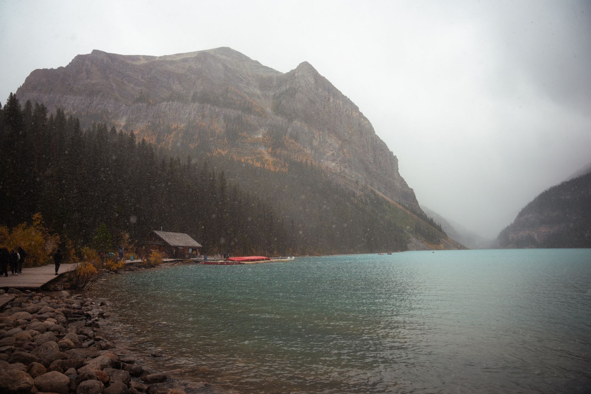 The Plain of Six Glaciers teahouse perched above the treeline with the lake visible far below