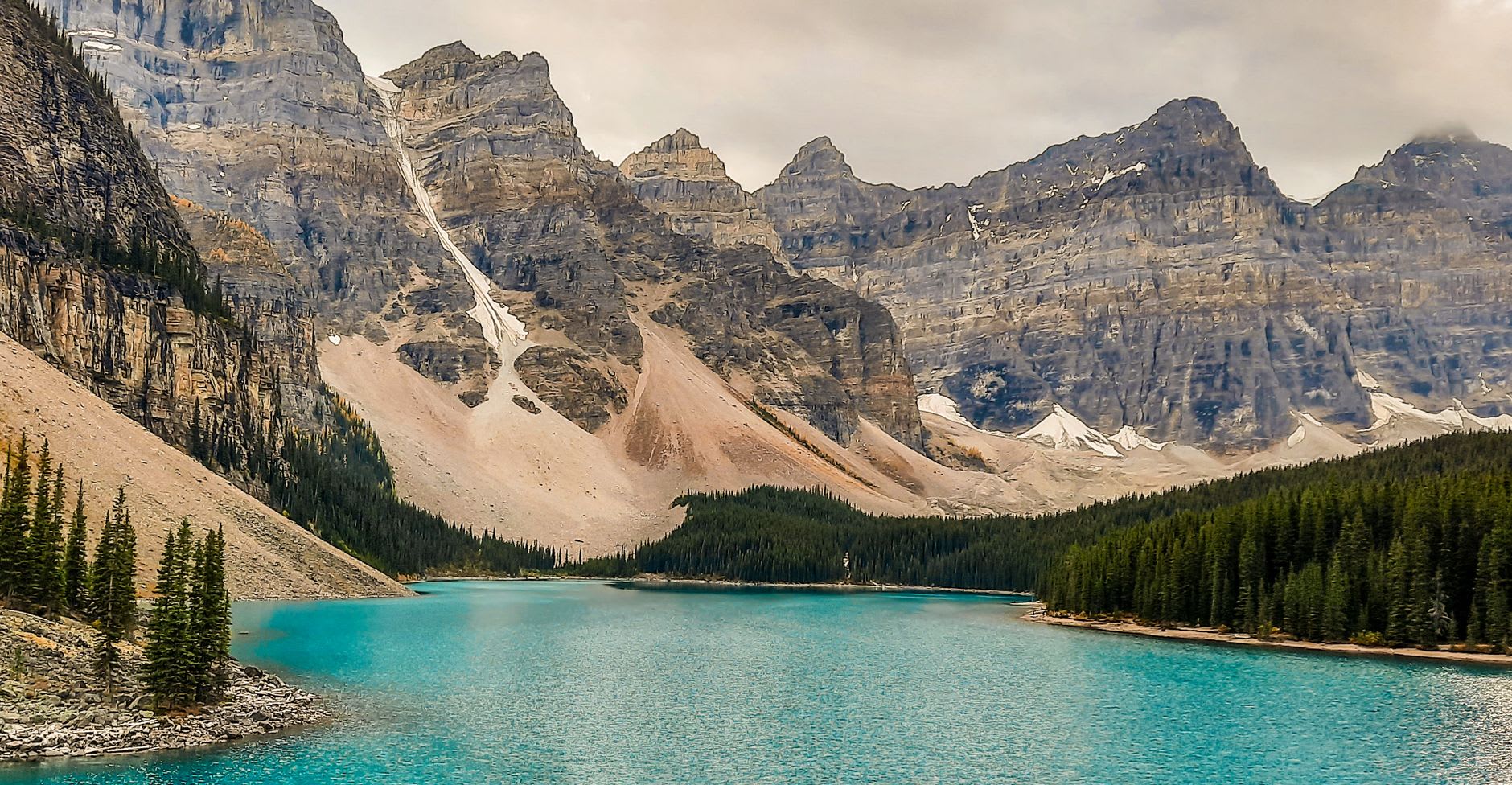 Moraine Lake at dawn with the Valley of Ten Peaks reflected perfectly in the still water