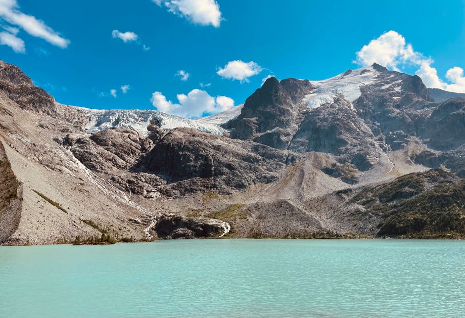 Glacier ice calving into the turquoise waters of a mountain lake