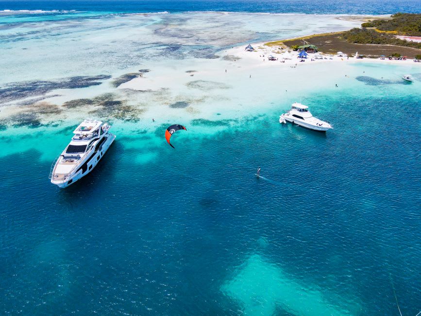 Kitesurfers riding the shallow turquoise lagoon at Sotavento Beach