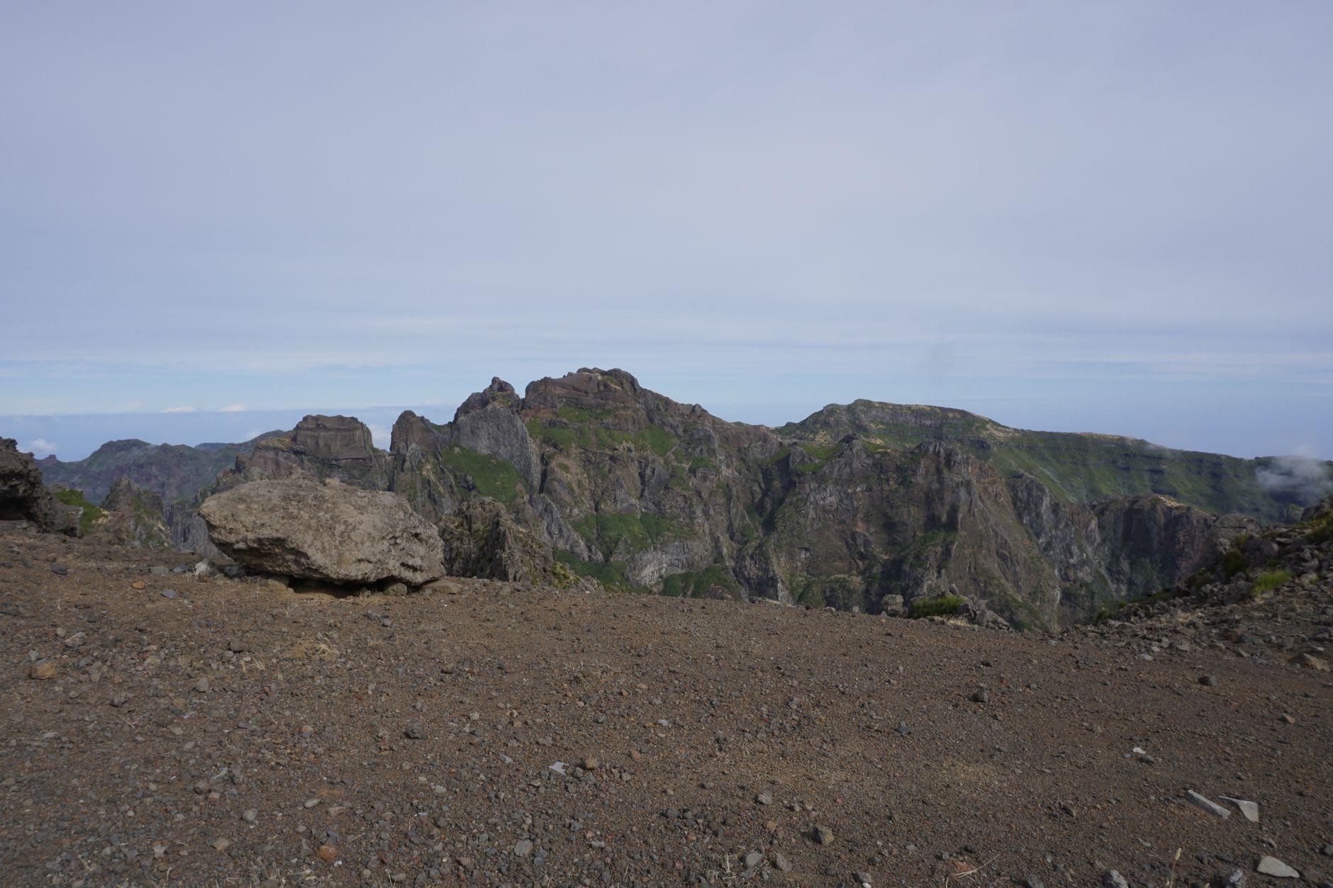 The view from inside the Chã das Caldeiras caldera at dawn, the caldera walls rising all around, faint light catching the cinder cone above