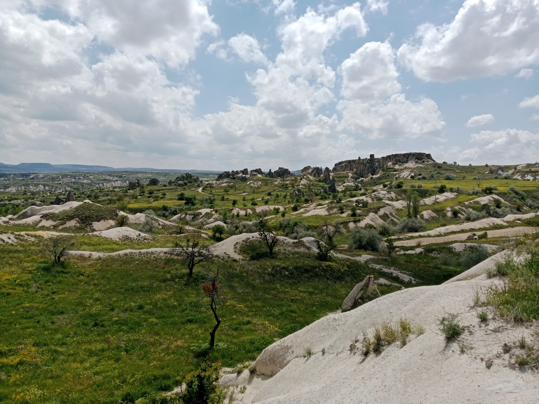 La escalera interna tallada del Castillo de Uçhisar, pasillos estrechos cortando a través de la roca volcánica hacia cámaras superiores y luz del día