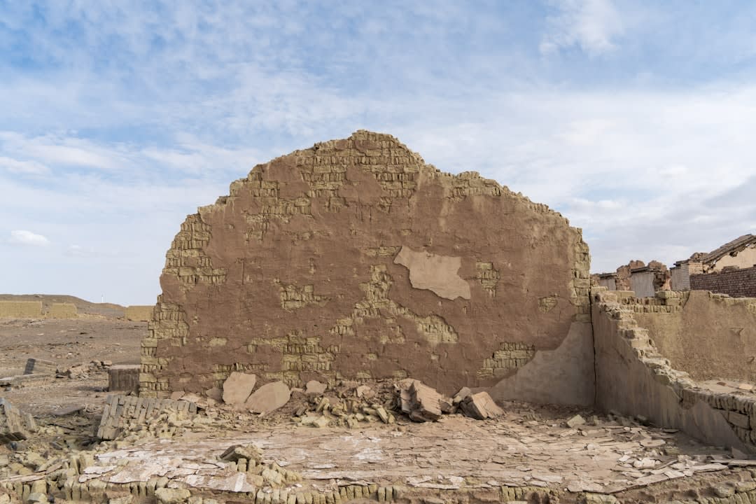 Weathered mudbrick ruins of the old sultanate palace walls at the edge of Ndélé