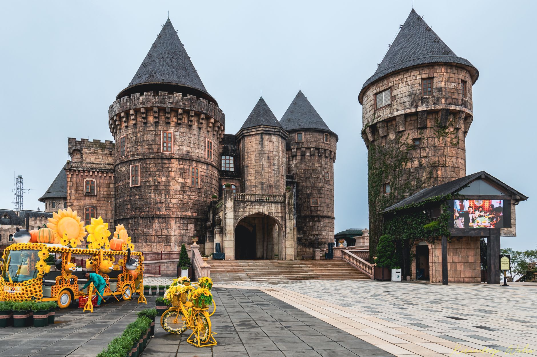 Tourists walking along the Golden Bridge held up by two giant stone hands above a sea of cloud at Ba Na Hills, Vietnam