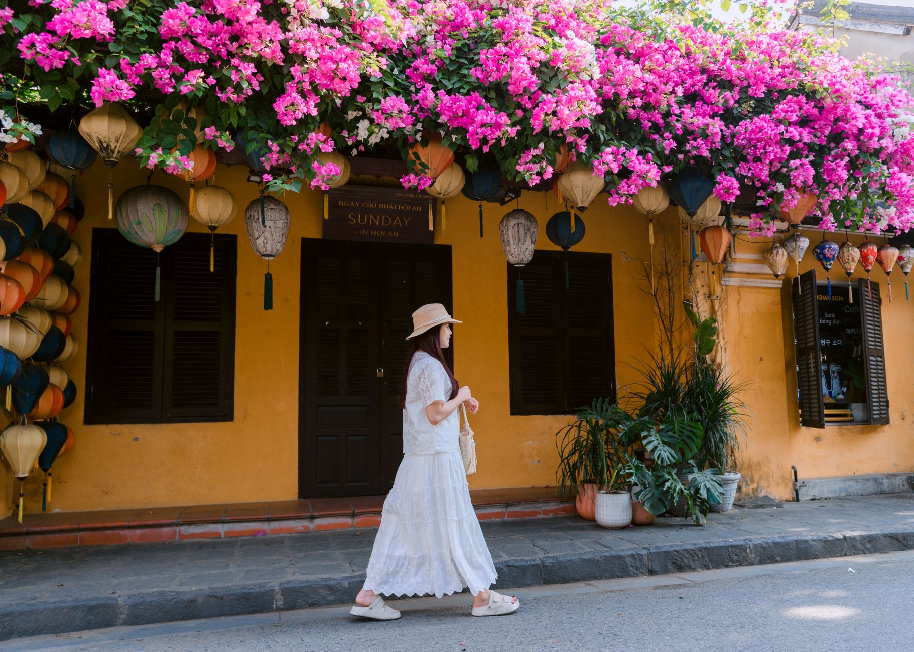 Morning mist rising off the Thu Bồn River canal beside the yellow-walled merchant houses of Hội An's old town