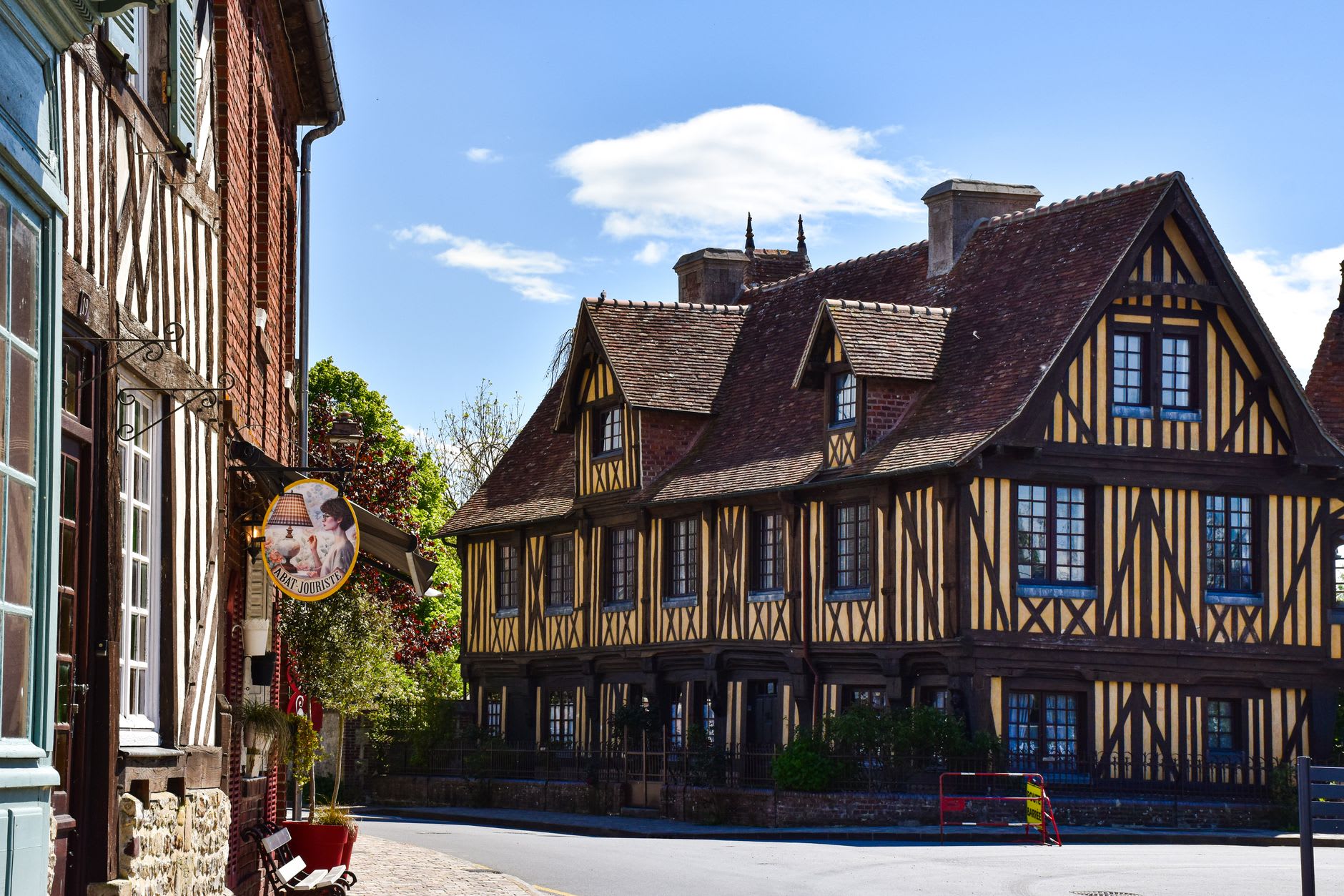 The ruelle des Chats in Troyes, a medieval alley so narrow the overhanging timber-framed houses almost meet overhead, the sky a thin strip of grey above