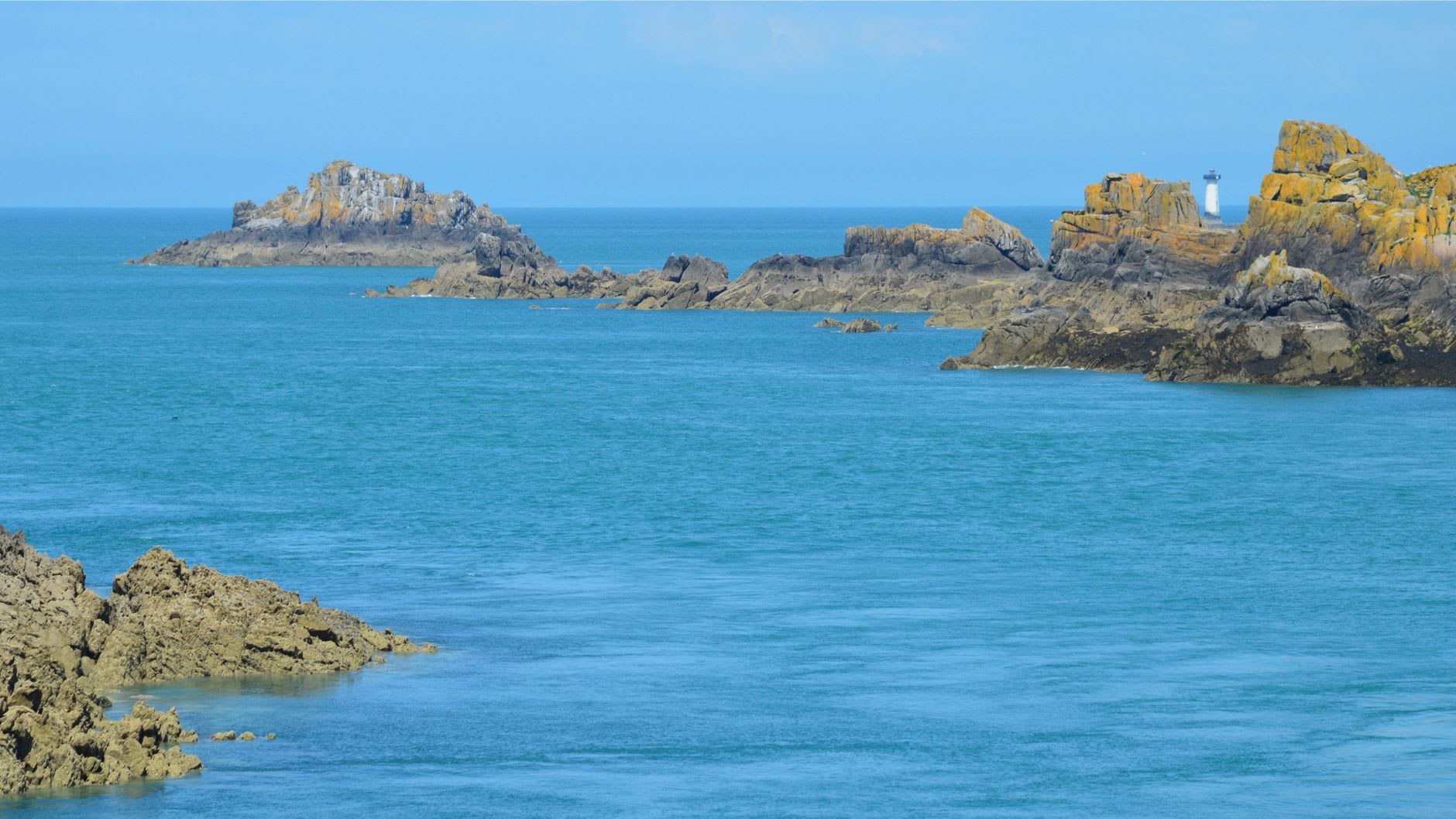 La Corbière lighthouse on its rocky islet connected to the mainland by the stepped tidal causeway at mid-tide