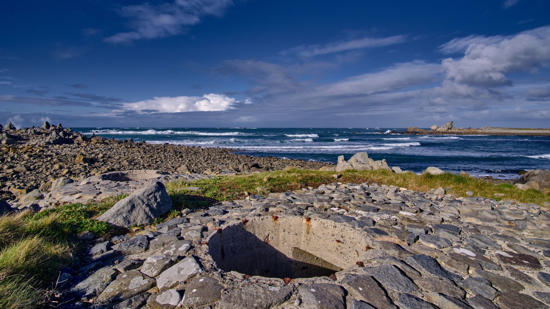 German WWII bunker embedded in the dune cliffs above St. Ouen's Bay, overtaken by grass and gorse