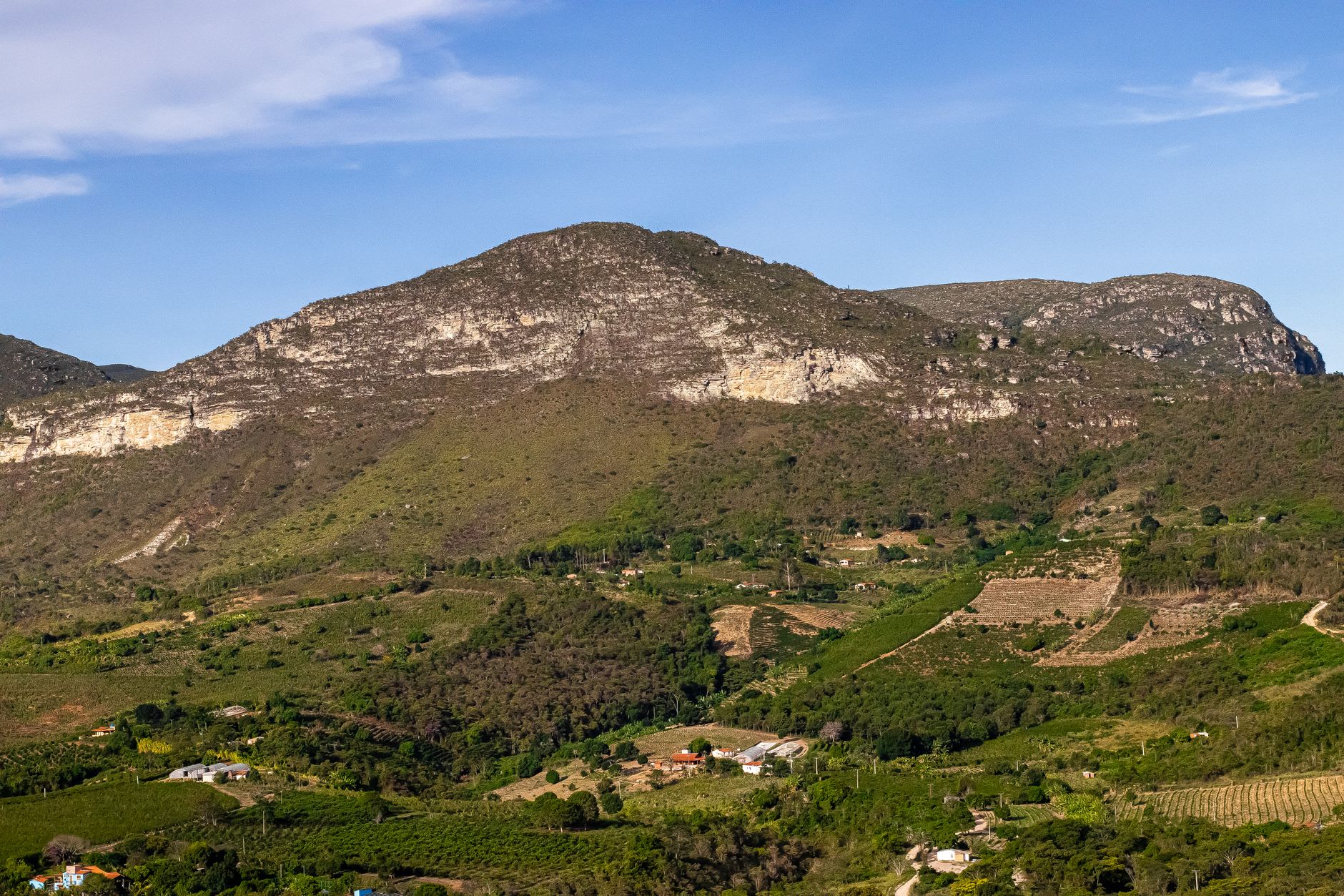Looking out from the summit of Morro do Pai Inácio over the Chapada Diamantina plateau, with a vast amber landscape stretching to the horizon