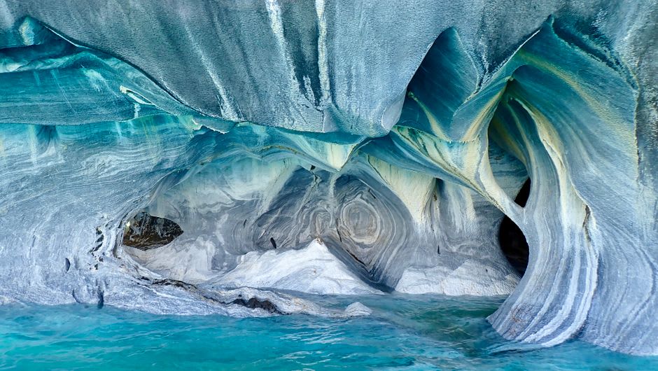 View from inside the boat looking out at the marble cathedral formation with the turquoise water of General Carrera Lake