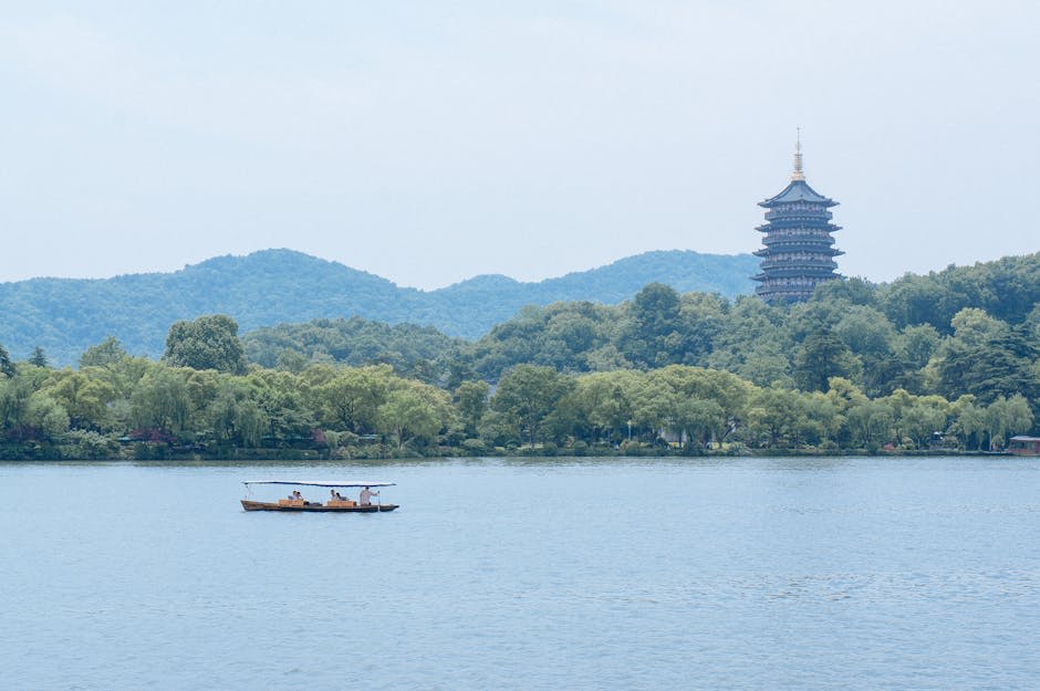 West Lake with pagoda and willows reflected in morning mist
