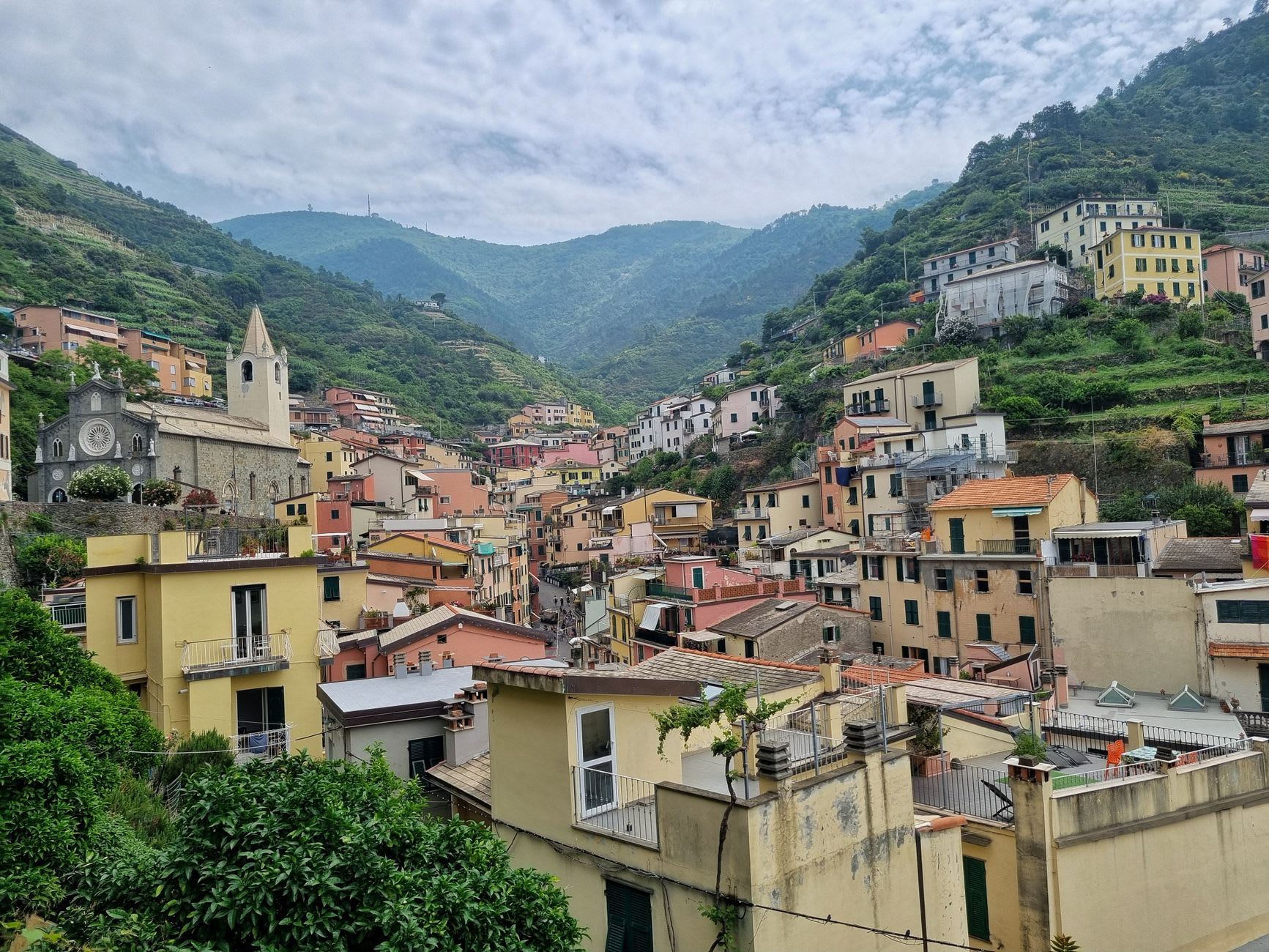 The panoramic view from the Montenero sanctuary terrace over the terraced Cinque Terre coastline and the deep blue Ligurian Sea