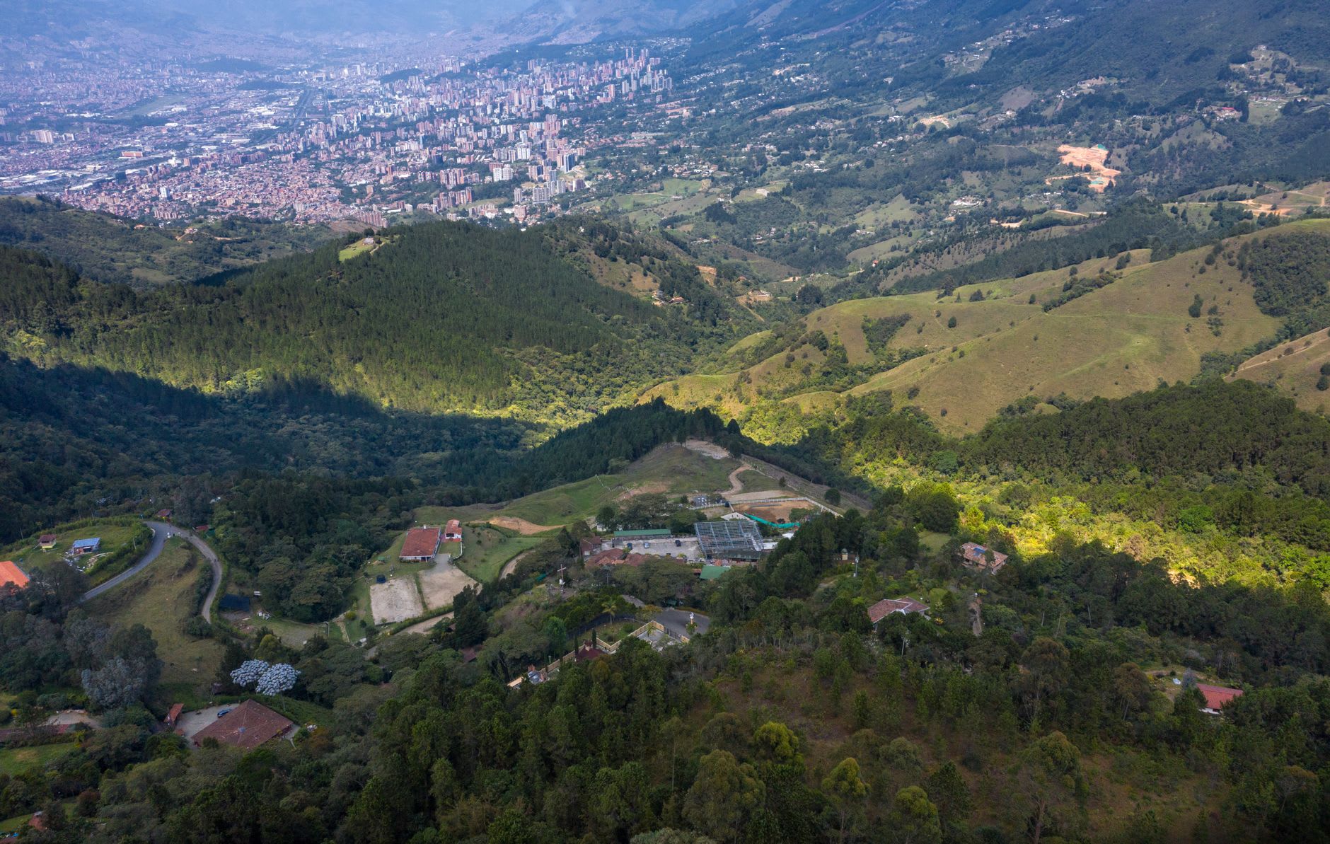 The Manizales cable car disappearing into low cloud above the rooftops of the city's eastern barrios