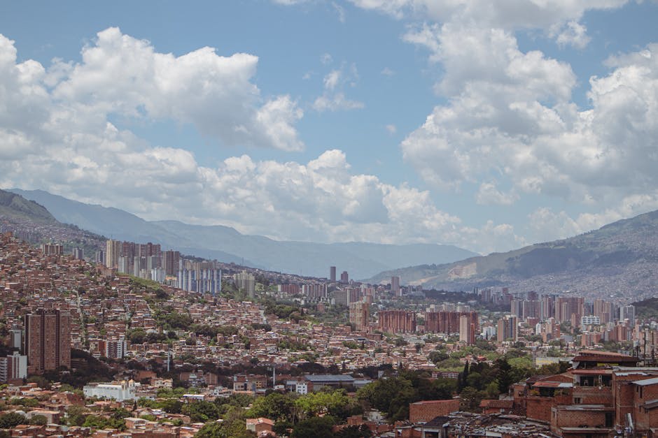A neighborhood street in Medellin with local architecture and mountain views