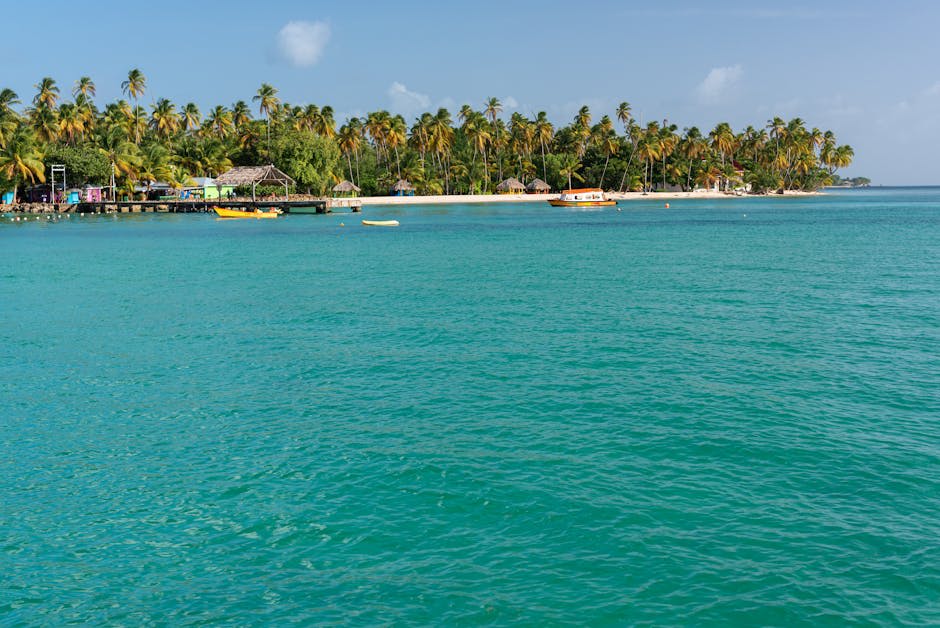 Colorful boats on the turquoise waters near a Caribbean island shore