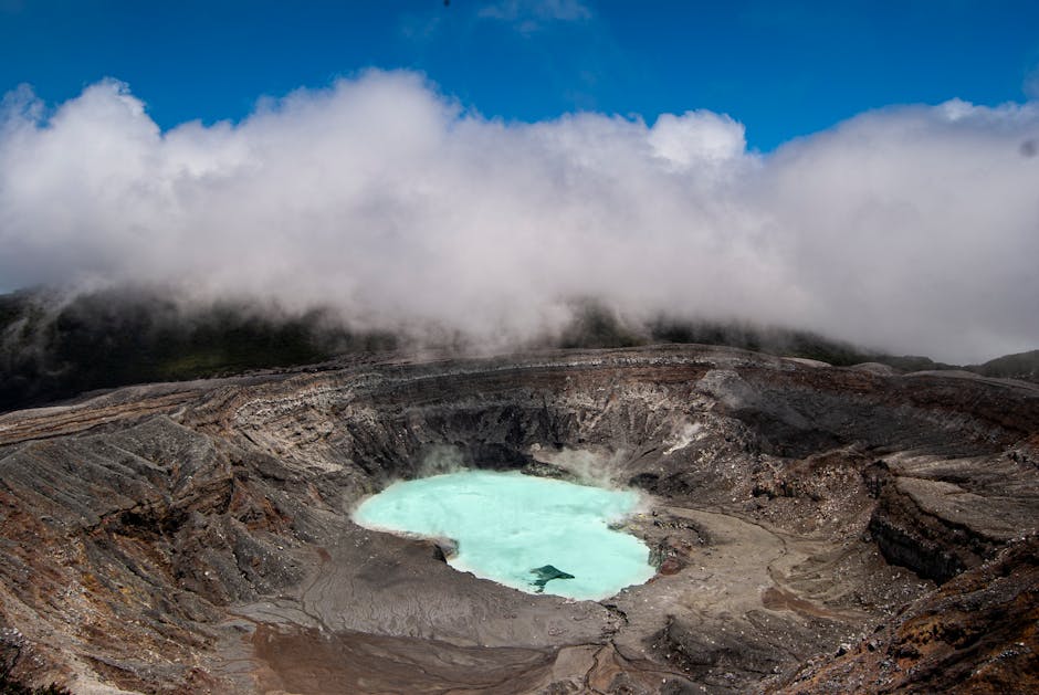Volcanic hot springs with steam rising through tropical vegetation