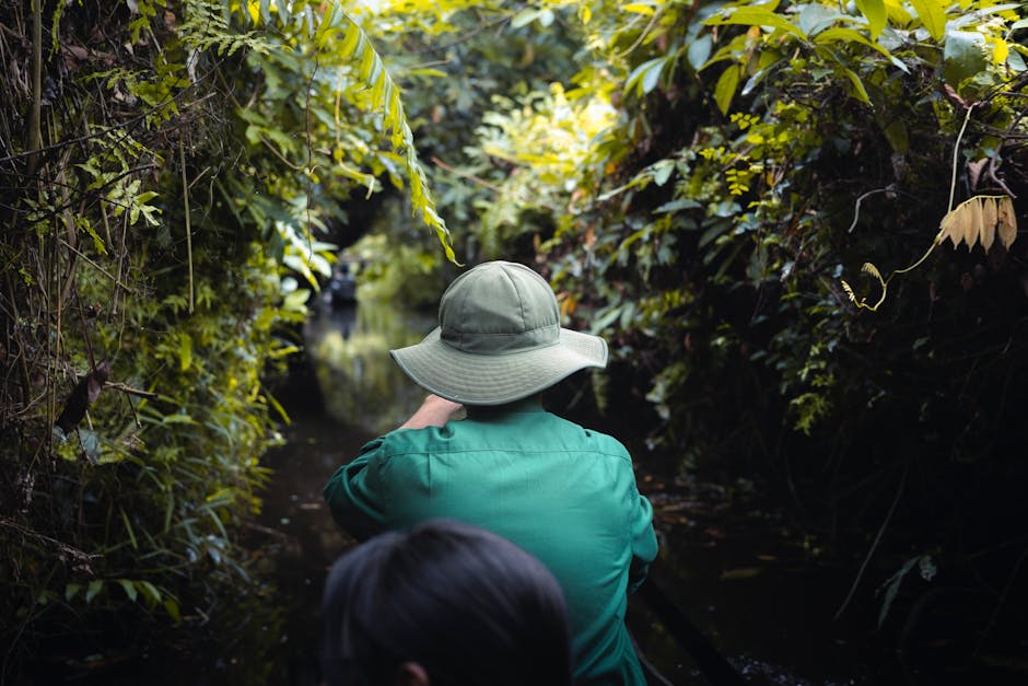 Boat navigating a narrow jungle-lined canal in Tortuguero