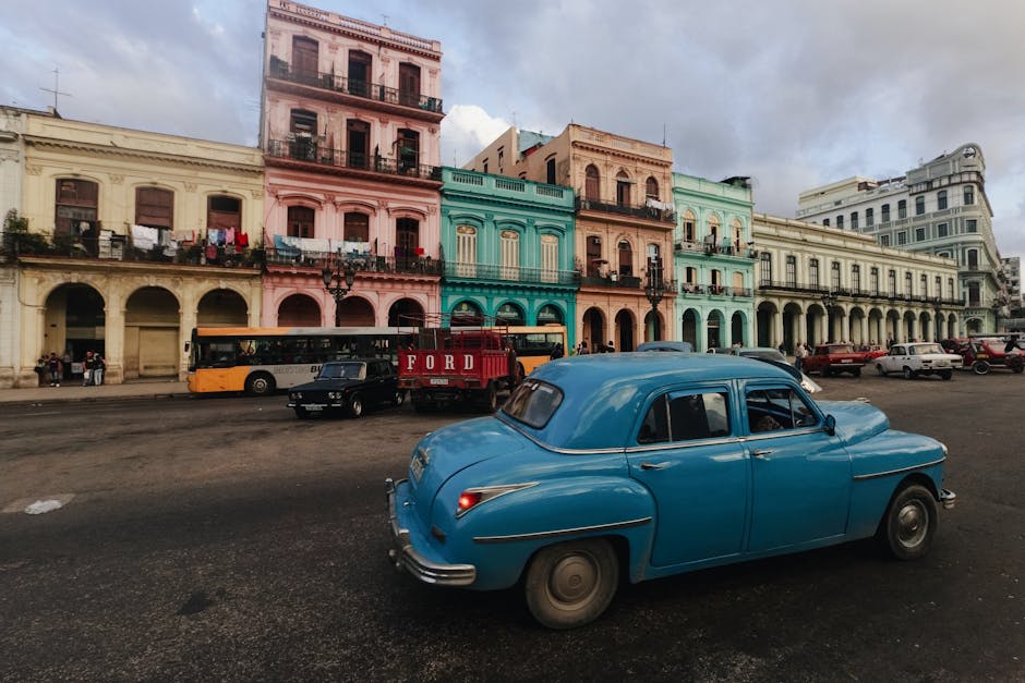 Vintage American cars parked along a colorful Havana street