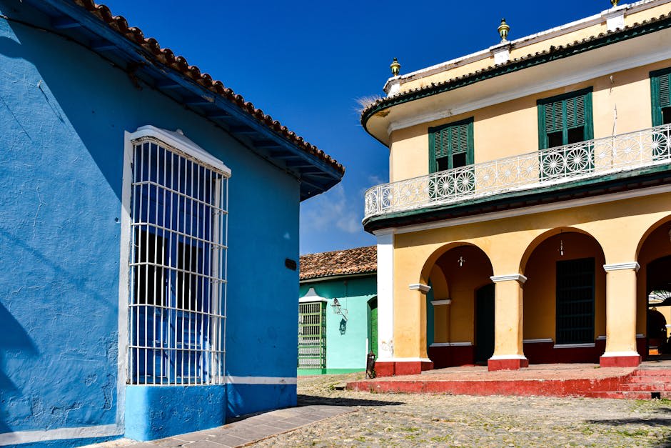 Colorful facades and palm trees in a Trinidad plaza