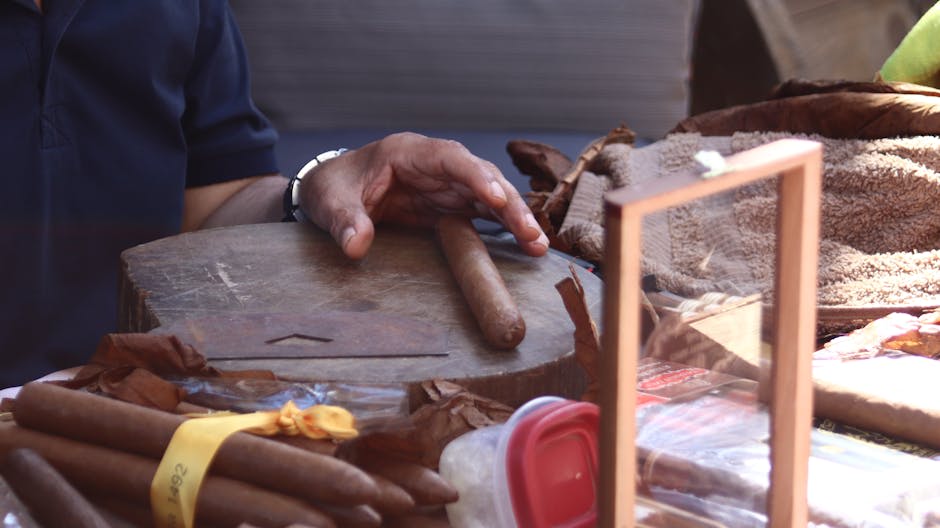 A Cuban tobacco farmer hand-rolling a cigar